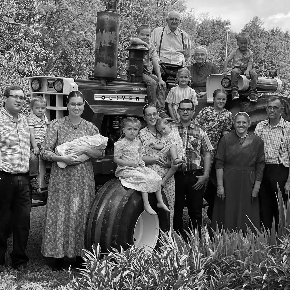 Photo of Martin Family Farmers standing in front of green tractor